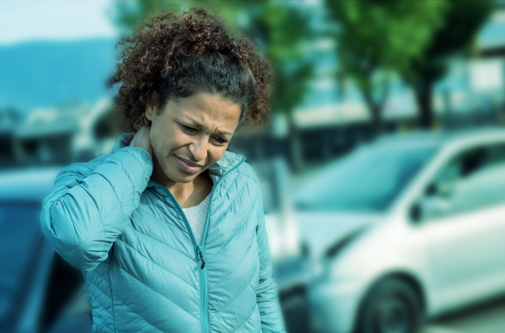 A woman holds her neck after an accident